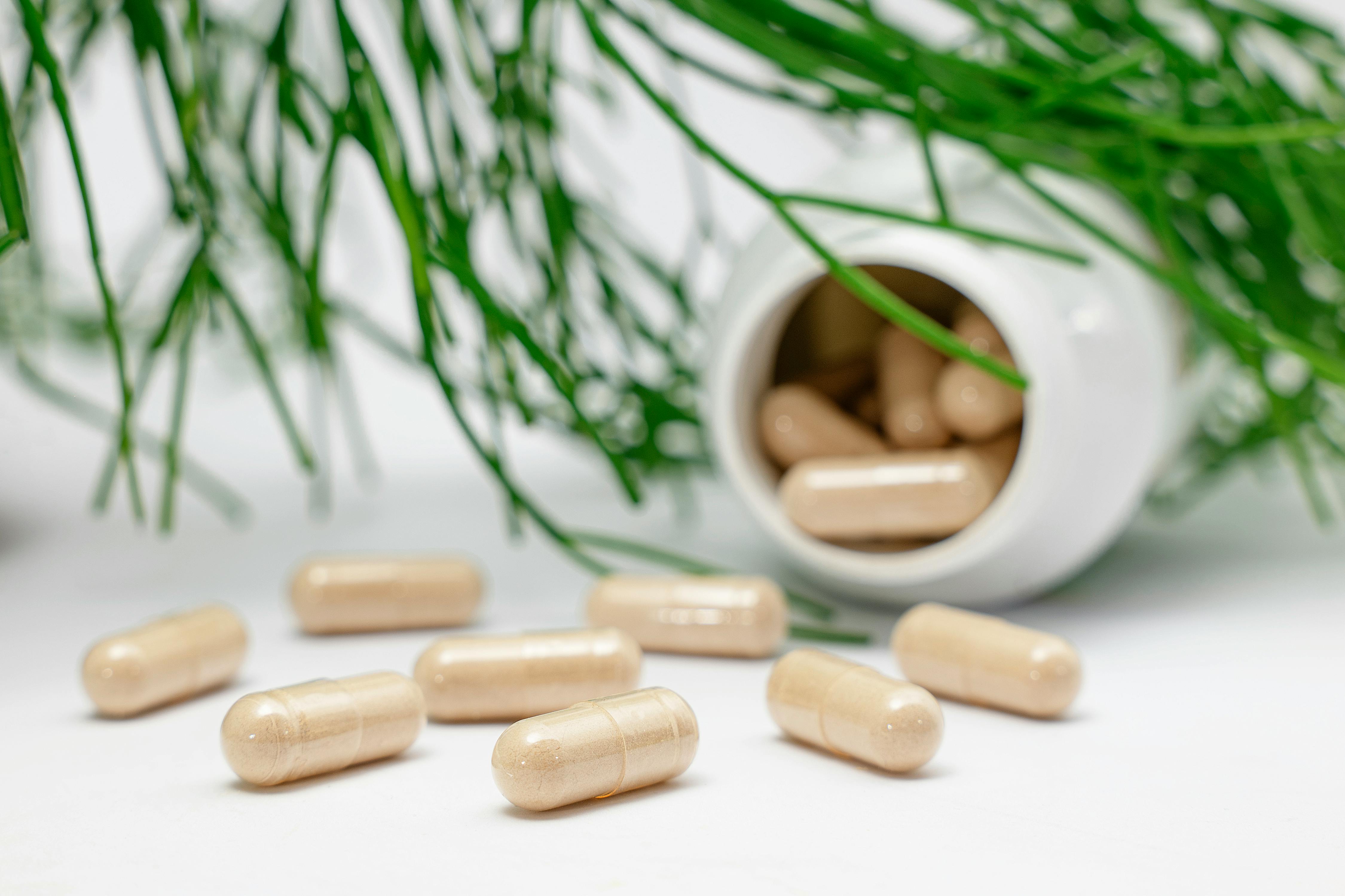 vitamin bottle with pills spread out